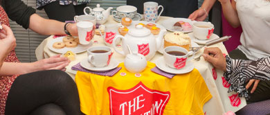 Salvation Army branded teapots and cups on a table