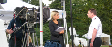 Salvation Army officer being interviewed by television news team