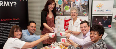 Group of people holding Salvation Army tea cups