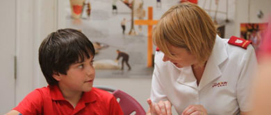 Young boy talking to Salvation Army soldier