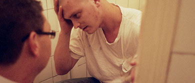 Addiction Support: Man with head in hands