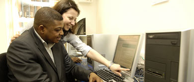 Two people working at a computer