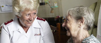 Older woman and Salvation Army officer talking